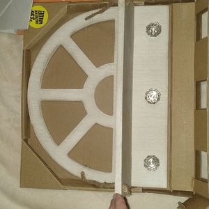 Decorative shelf with 3 knobs for hanging things on the wall.
